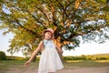 Child and a huge tree in the forest. old oak and a little girl Royalty Free Stock Photo