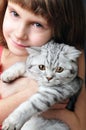 Child hugging silver white cat kitten Royalty Free Stock Photo