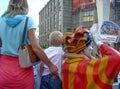 The child hugs the sculpture of the clown by the neck