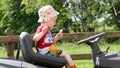 Child on Husqvarna TC 138 Ride-On Lawn Mower