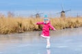 Child ice skating on frozen mill canal in Holland Royalty Free Stock Photo