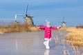 Child ice skating on frozen mill canal in Holland. Royalty Free Stock Photo