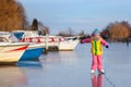 Child ice skating on frozen mill canal in Holland Royalty Free Stock Photo