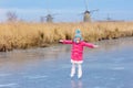 Child ice skating on frozen mill canal in Holland Royalty Free Stock Photo