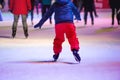 Child ice skating at night in Vienna, Austria. Winter. Royalty Free Stock Photo