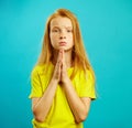 Child with imploring glance, she folded her hands at the breast in sign of supplication or request, expressed apology Royalty Free Stock Photo