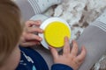 A child independently tries to open a plastic bottle of medicine, close-up. Child-resistant, childproof or CR packaging. Push&Turn Royalty Free Stock Photo