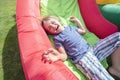 Child on inflatable bouncy castle slide Royalty Free Stock Photo