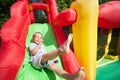 Child on inflatable bouncy castle slide Royalty Free Stock Photo