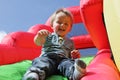 Child on inflatable bouncy castle slide Royalty Free Stock Photo