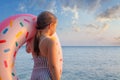 Child with inflatable ring. Little girl learning to swim with pink donut float. Water toy for baby and toddler. Royalty Free Stock Photo