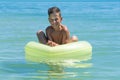 Child with inflatable ring in sea