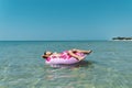 Child with inflatable ring in sea