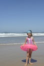 Child with inflatable swimming ring at the beach