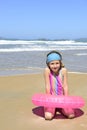 Child with inflatable swimming ring at the beach