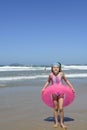 Child with inflatable swimming ring at the beach