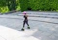 Child on inline skates in park. Kids learn to skate roller blades. Little girl skating on sunny summer day. Royalty Free Stock Photo