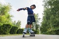 Child on inline skates in park. Kids learn to skate roller blades. Little girl skating on sunny summer day. Outdoor activity for Royalty Free Stock Photo