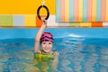 Child in swimming pool excersizing with sport rings Royalty Free Stock Photo