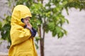 Child, jacket and rain in outdoor for fashion, play and walk to kindergarten in cold. Boy, cute and adorable kid with Royalty Free Stock Photo