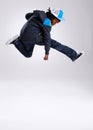 Child, jump and dancing with hiphop and street style clothing in a studio with boy dancer. Trendy, energy and cool Royalty Free Stock Photo