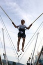 Child jumping on bungee trampoline Royalty Free Stock Photo