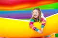 Child jumping on colorful playground trampoline