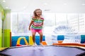 Child jumping on colorful playground trampoline Royalty Free Stock Photo