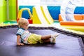 Child jumping on colorful playground trampoline Royalty Free Stock Photo