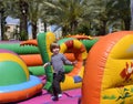 Child jumping on colorful playground trampoline. Kids jump in inflatable bounce. Royalty Free Stock Photo