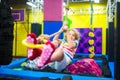 Child jumping in trampoline park. Bounce fun