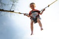Child jumping child trampoline rubber bands Royalty Free Stock Photo