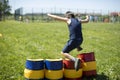 A child jumps over an inflatable obstacle. Obstacle course for children