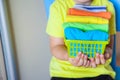 The child keeps his things. The boy puts the T-shirts in a drawer.