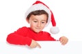 Child kid boy Christmas Santa Claus pointing empty banner copyspace isolated Royalty Free Stock Photo