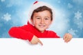 Child kid boy Christmas Santa Claus pointing happy empty banner copyspace