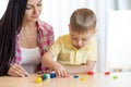 Child kid boy and his mom playing colorful clay toy at nursery or kindergarten Royalty Free Stock Photo