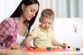 Child kid boy and his mom playing colorful clay toy at nursery or kindergarten Royalty Free Stock Photo