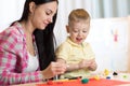 Child kid boy and mother play colorful clay toy at nursery or kindergarten Royalty Free Stock Photo