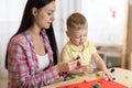 Child kid boy and mother play colorful clay toy at nursery or kindergarten Royalty Free Stock Photo