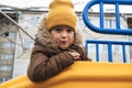 child kid boy playing on a slide on playground in winter in the park Royalty Free Stock Photo
