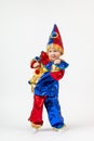 Child kid boy preschooler in Harlequin, Arlecchino, Arlequin, costume dancing. Vertical shot isolate on white background. Concept