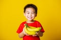 Child or kid cute little boy attractive smile playing holds bananas comb fruit Royalty Free Stock Photo