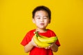 Child or kid cute little boy attractive smile playing holds bananas comb fruit Royalty Free Stock Photo