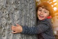 Child kid embracing tree environmental protection outdoor nature Royalty Free Stock Photo
