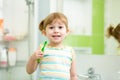 Child kid girl brushing teeth in bathroom Royalty Free Stock Photo