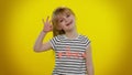 Child kid girl looking approvingly at camera showing ok gesture, like sign positive something good Royalty Free Stock Photo