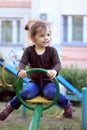 Child kid girl swinging on a playground swing Royalty Free Stock Photo