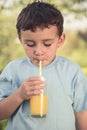 Child kid little boy drinking orange juice drink outdoor vintage Royalty Free Stock Photo