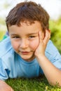 Child kid little boy thinking think looking meadow outdoor portrait format Royalty Free Stock Photo